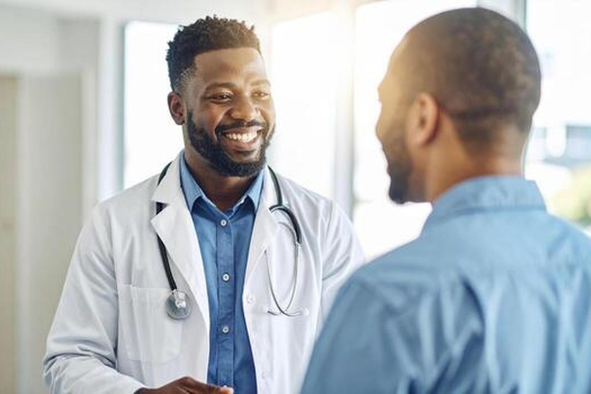 A clinician smiling while talking with a patient