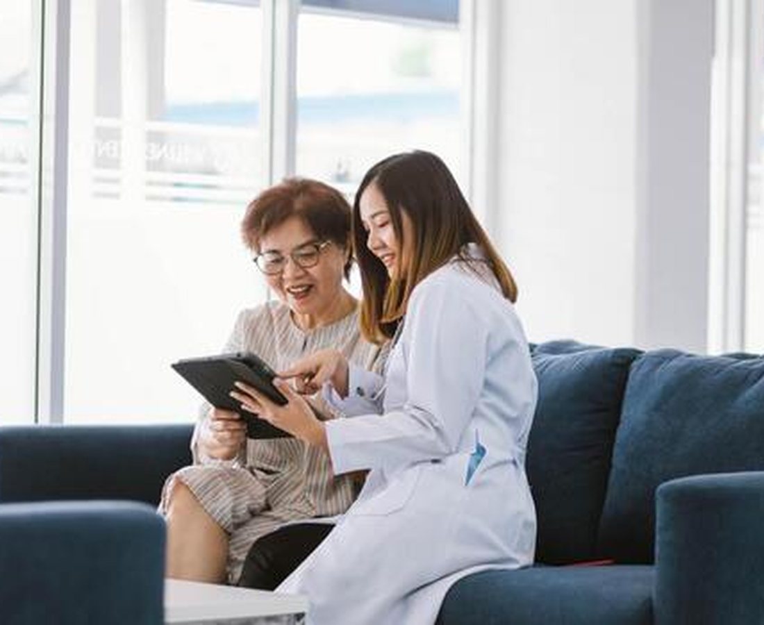Care team member reviewing a health plan with a patient in a bright clinic room